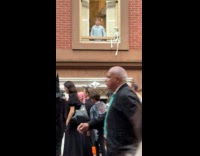 Kid closes window with Halloween view outside