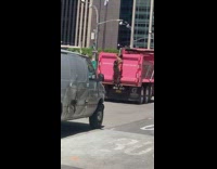 Shirtless Guy with Backpack Climbs onto Pink Truck 