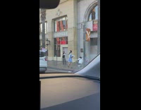 Woman in a sexy cat costume at the sidewalk