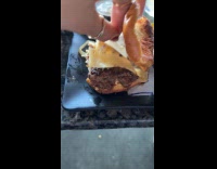 Woman accidentally eats cheese paper on burger