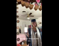 Lady in Graduation Robe Cries in Front Mirror