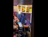 Guy singing karaoke bar