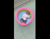 Baby sleep on kiddie pool floating on swimming pool