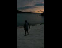 Man roll down beach sand sundown