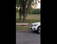 Guy surf ride electric skateboard on grass