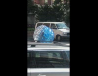 Orange shirt guy wears blue plastic ball 