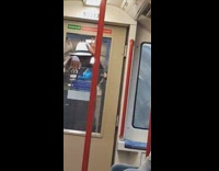 Man dancing sticking hands through subway door