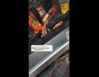 Girl puts hand into vending machine to take kitkat chocolate 