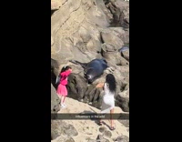 Mother and daughter poses beside sea lion