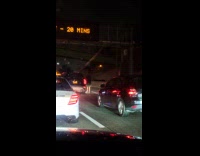 Guy walking next to black fiat car