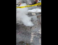 Sewer boils water with smoke on street