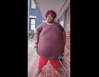 Plus sized woman does squat challenge to the ground 