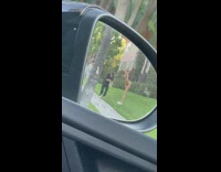Woman in a green bikini poses on the yard