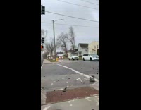 Woman with safety vest and stop sign directing traffic