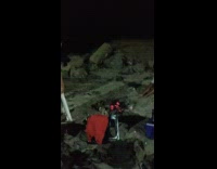 Purple shirt guy fans bonfire fire beach