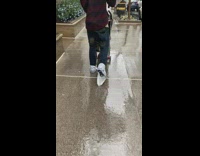 Guy walks with plastic bag on shoes 