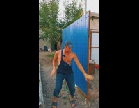 Guy wearing overalls takes photo freaks out