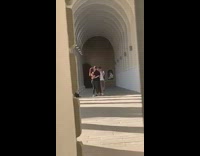 Couple hug kiss pose church outdoor hallway