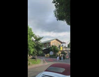 Three girls fake laugh skip together street