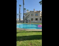 Woman violet bikini hold on pool handrails