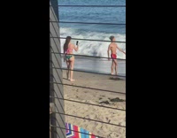 Guy red shorts dance  beach wine glass