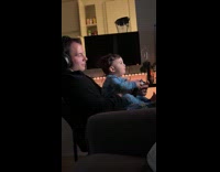 Man playing videogames with toddler son 