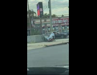 Guy hospital gown red mobility scooter sidewalk 