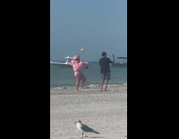 Woman pink fur hat jacket hold microphone beach