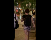 Collab WINY - Woman walking with bone sticking out from backpack