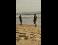 Brown shirt guy walks beach shore turban 