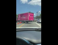Pink truck runs over cones to get on freeway 