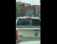Driver rests bare foot on side mirror 