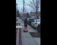 a person dragging a black crate on street