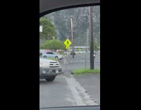 Woman in red floral bottoms Hawaiian dance on the parking lot