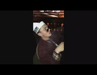 A guy mimics the Godfather with a cigar 