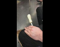 Man shucks opens oyster shell and eats it on subway train