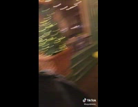 Three guys looking at girl in front of green door 