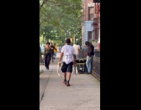 Man walks with two snakes on hand