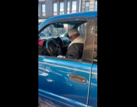 Man inside car dances and sing outside