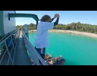 White shirt wetsuit guy front flip lake 