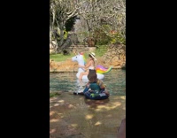 Woman in bikini rides on inflatable unicorn
