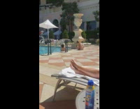 Pink dress girl squats friend in pool