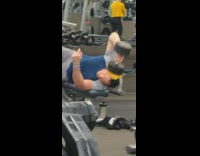 man puts weight on head and exercises  