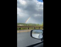 Rainbow after storm seen from road trip