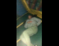 Girl jumps in bounce house jumper and scorpions green pants