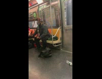 Guy does arm workout with bands on train 