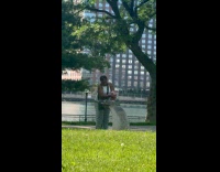 Woman wash meat at park water fountain 