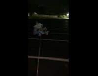 Guy drifting through parking lot in blue toy car 