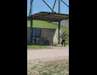 Black shorts lady squats bicycle park