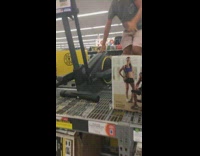 Guy uses elliptical on shelf at store